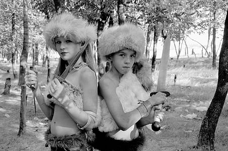 grayscale photo of boy and girl holding weapon s thumbnail