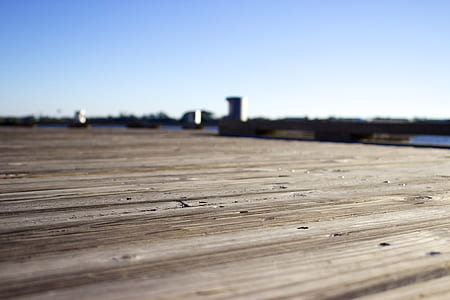 tilt shift lens photography of brown wooden dock thumbnail