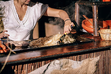 woman standing in front of grilling stand at daytime thumbnail