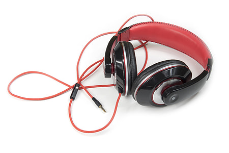 red and black corded headphones on white tabletop thumbnail