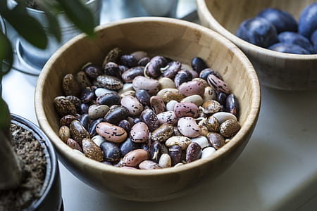 assorted-color stones on round brown wooden bowl thumbnail