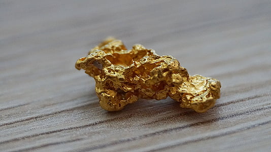 selective focus photography of gold-colored stone thumbnail