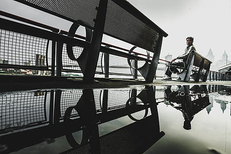 worm's eye view of man sitting on bench thumbnail