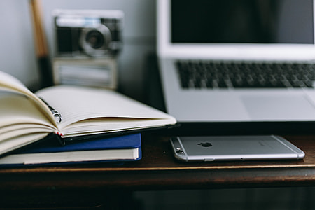 Elegant workspace with Macbook, iPhone, business cards and notebooks thumbnail