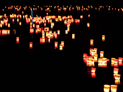 lighted paper lantern on body of water thumbnail