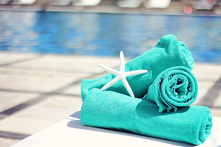 three teal towels and white star fish photo thumbnail
