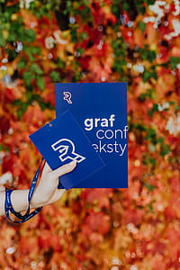 Girl with the Grafconf book on the background of colourful leaves thumbnail