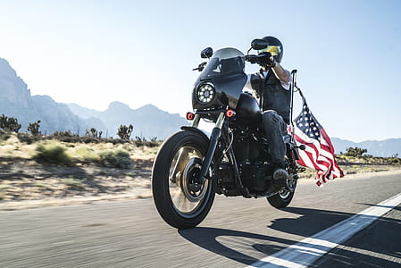 man riding black touring motorcycle in rule of thirds photography thumbnail