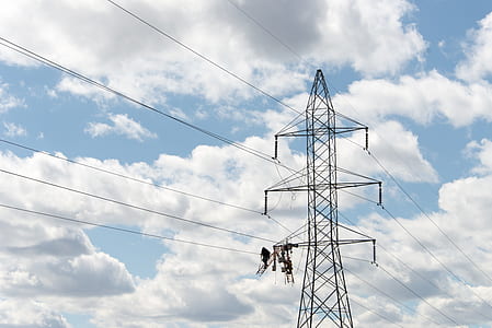 grey transmission line under white cloudy sky thumbnail