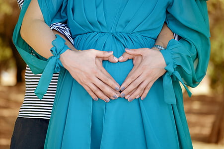 woman wearing green dress holding man's hands thumbnail