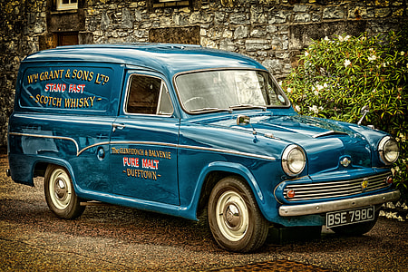 white Scotch Whisky truck parked near concrete building thumbnail