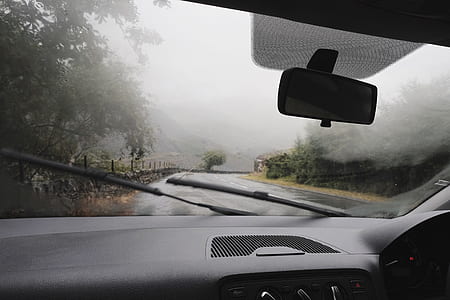 person driving vehicle running on wet curved road at rainy daytime thumbnail