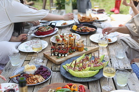 group of persons eating on brown wooden table thumbnail