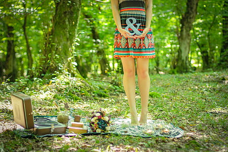 Woman Standing on Picnic Mat Holding Ampersand Lettering thumbnail