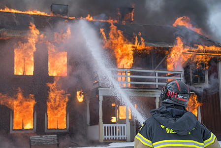 fireman extinguishing burned house thumbnail