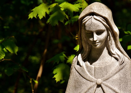 woman concrete statue beside green leafed plant thumbnail