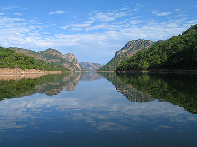 calm body of water between mountains at daytime thumbnail