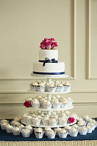 2-tier cake on top of round 4-tier cupcake rack with cupcakes thumbnail