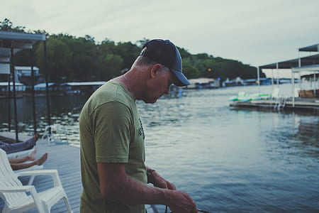 man standing in front of body of water at daytime thumbnail