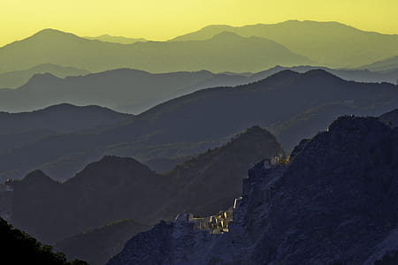 buildings beside mountain thumbnail