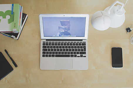 MacBook Air beside black smartphone thumbnail