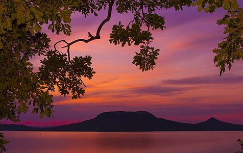 mountain near body of water during golden hour thumbnail