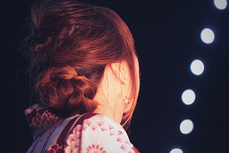 photo of woman with red hair in white and red floral top looking at the sky thumbnail