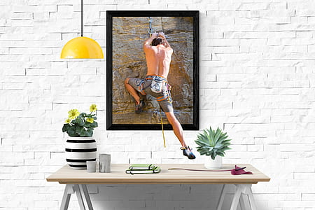 man in gray shorts painting with black wooden photo frame thumbnail