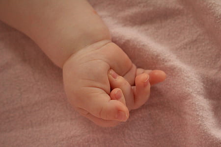 baby hand on gray textile thumbnail