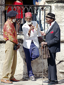 three men standing near gray concrete wall during daytime thumbnail
