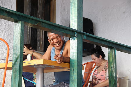 man sitting on chair while showing smile thumbnail
