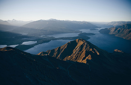 aerial view photography of mountain and body of water during daytime thumbnail