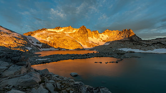 landscape photography of mountain near river at daytime thumbnail