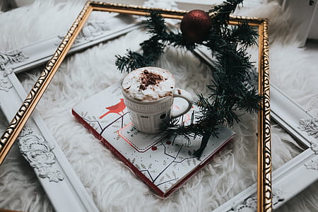 white ceramic mug on top of picture frame thumbnail