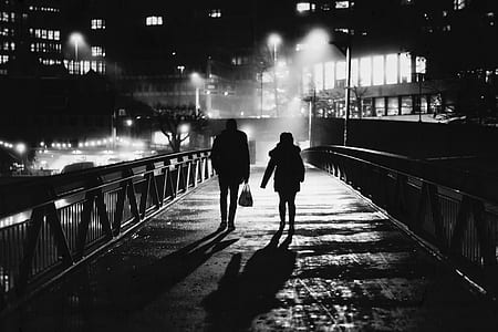 silhouette of man and woman walking on bridge thumbnail