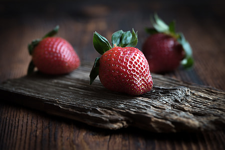 selective focus photo of red strawberry on brown wooden board thumbnail