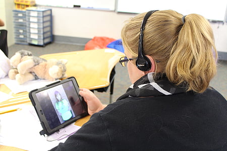 woman holding turned-on tablet computer thumbnail