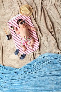 baby lying on red and white blanket with summer-themed photography thumbnail