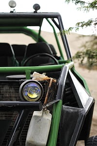green and black UTV parked near trees at daytime thumbnail