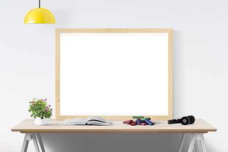 dry erase board with brown wooden frame on wooden table thumbnail