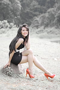 woman sitting on gray rock selective color photography thumbnail