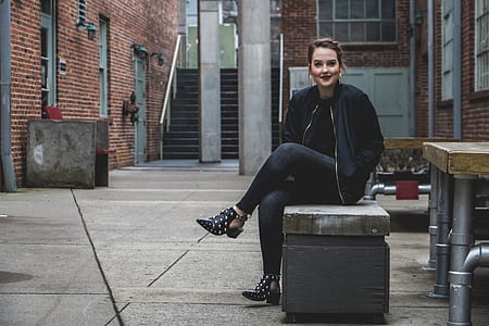 woman in black jacket sitting on bench thumbnail