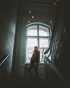woman climbing up on stairs inside well lighted room thumbnail