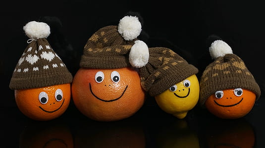 three orange citrus fruit and one lemon wearing hats decors thumbnail