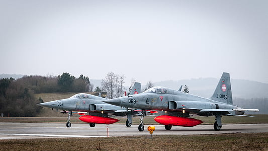 two fighter jets park in wide narrow road thumbnail