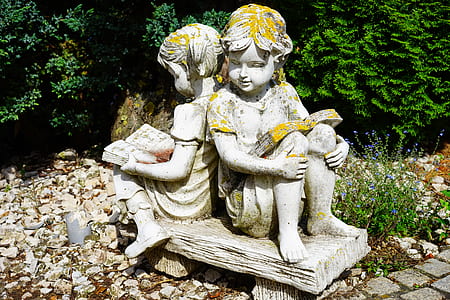 selective focus photography of boy and gray statues thumbnail