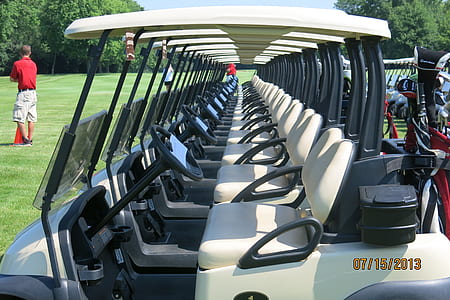 white golf cart near trees thumbnail