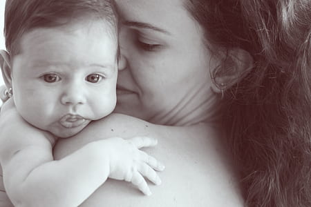 grayscale photo ofo woman carrying baby thumbnail