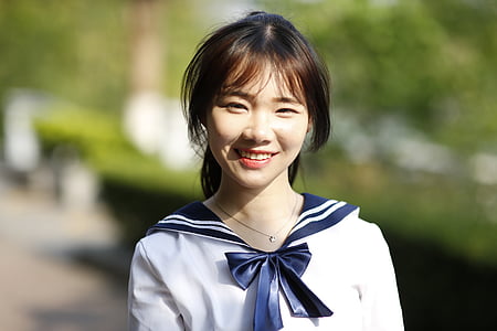 woman wearing blue and white uniform dress thumbnail