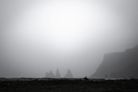 silhoutte of mountain behind fog thumbnail